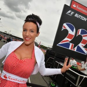 formula 1 gird girl holding jenson button team flag